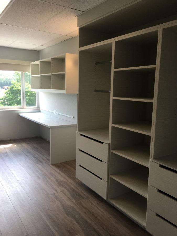 another perspective of the renovated residence hall room with shelves, closet and desk space.