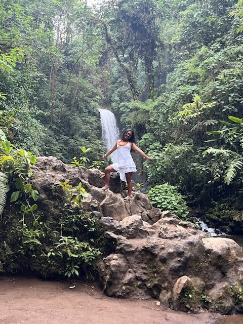 A Kettering College student from Costa Rica poses at a waterfall.