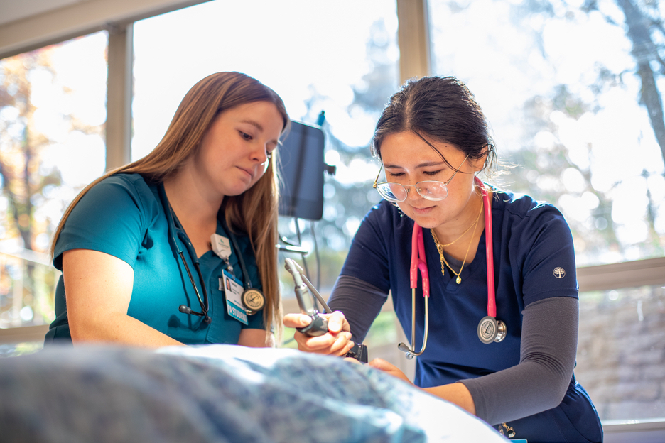 Two Physician Assistant Studies students at Kettering College work together in a lab on campus.