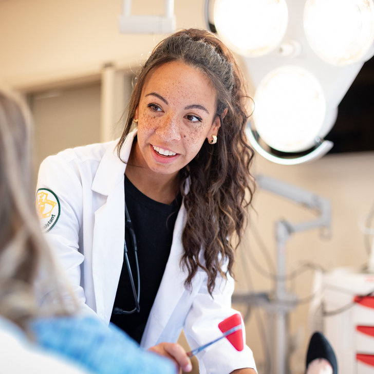 A Physician Assistant Studies student at Kettering College works on a patient during a clinical experience.