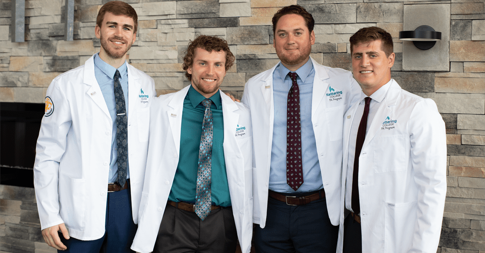 Four Physician Assistant Studies students at Kettering College attend a white coat ceremony to symbolize their commitment to their patients.