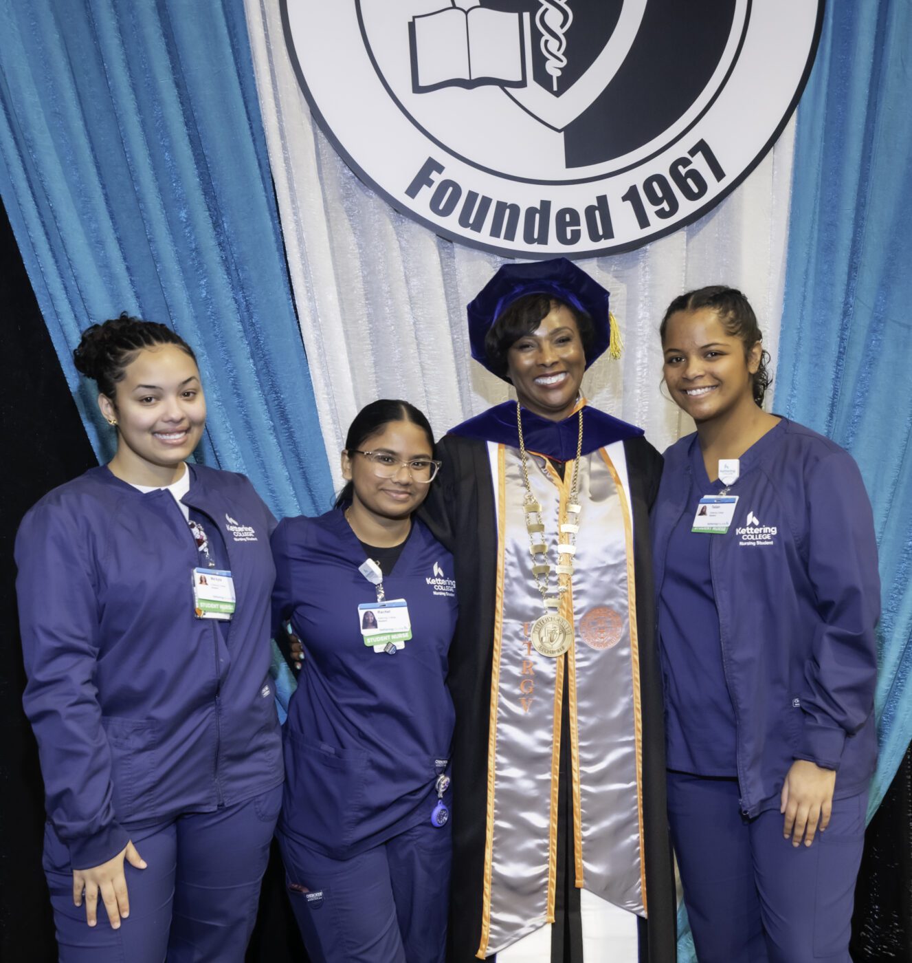 President Mitchell posing with nursing student eager for a picture with her on this historic day. 